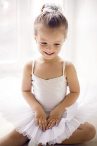 Little ballerina girl 2 years in the studio in a white tutu dress clothes