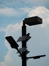 Low angle view of telephone pole against sky