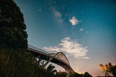 Low angle view of bridge against sky at night