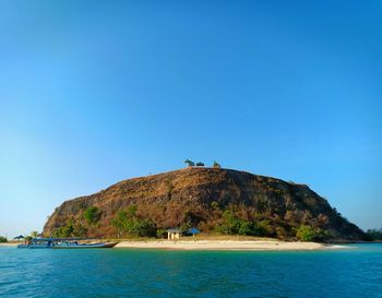 Scenic view of sea against clear blue sky