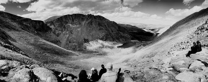 People on mountain against sky