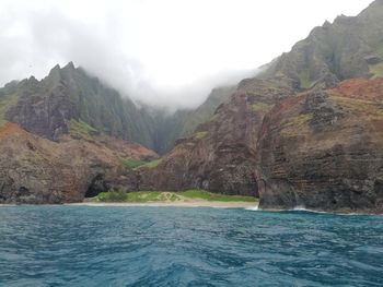 Scenic view of sea and mountains against sky