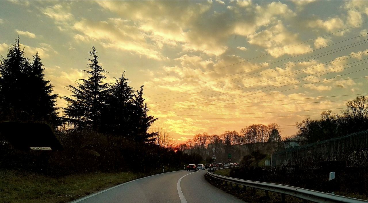 VIEW OF COUNTRY ROAD AT SUNSET