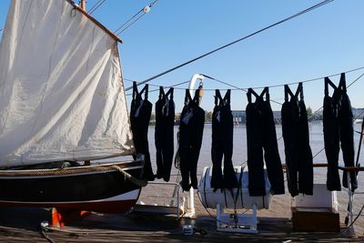 People standing on bridge against clear sky