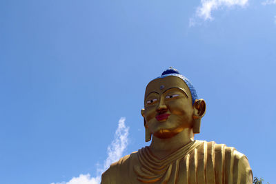 Low angle view of statue against blue sky