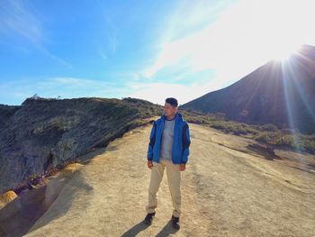 Man standing on mountain against sky