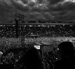 Silhouette of people against cloudy sky