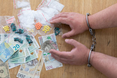 Dealer in handcuffs for possession of a substantial amount of drugs.