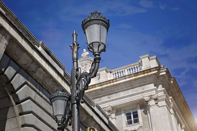 Low angle view of street light against building