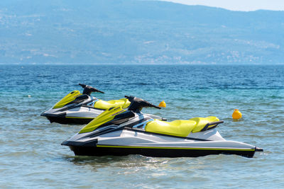 A pair of jet skis on sea near beach