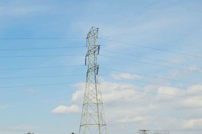 Low angle view of electricity pylon against sky