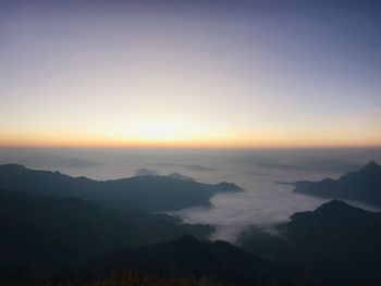 Scenic view of silhouette mountains against sky during sunset