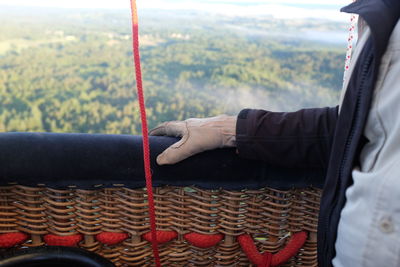 Cropped image of person standing in hot air balloon
