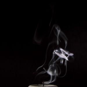 Close-up of lamp over black background