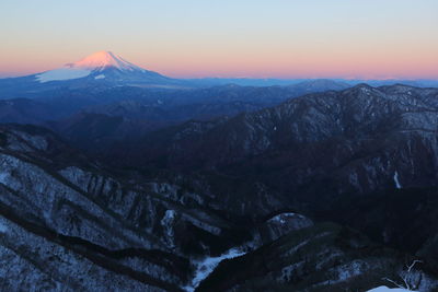 Scenic view of snowcapped mountains against sky during sunset