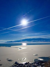 Scenic view of beach against blue sky