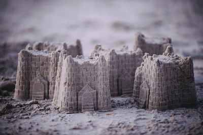 Close-up of sand castles at beach