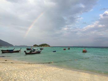 Scenic view of rainbow over sea against sky