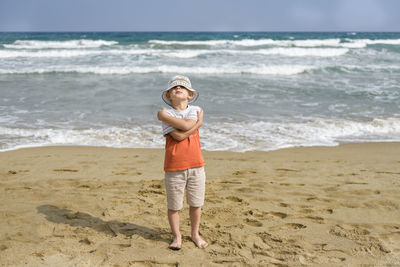 Full length of boy standing on beach