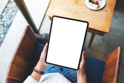 Midsection of woman using digital tablet