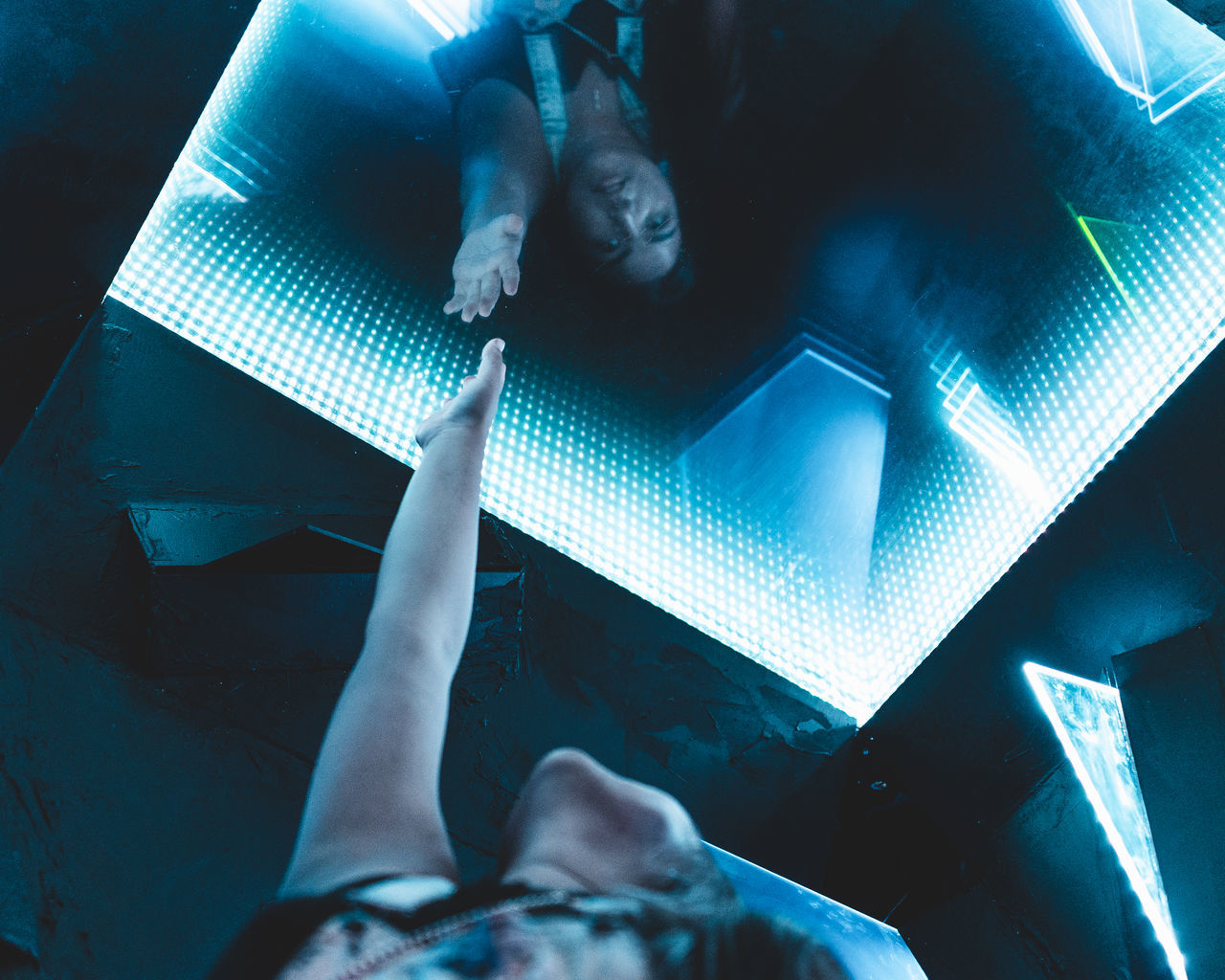 LOW SECTION OF PEOPLE RELAXING ON ILLUMINATED STAGE