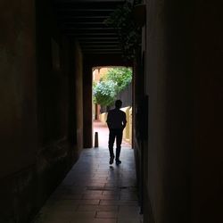 Rear view of people walking in corridor