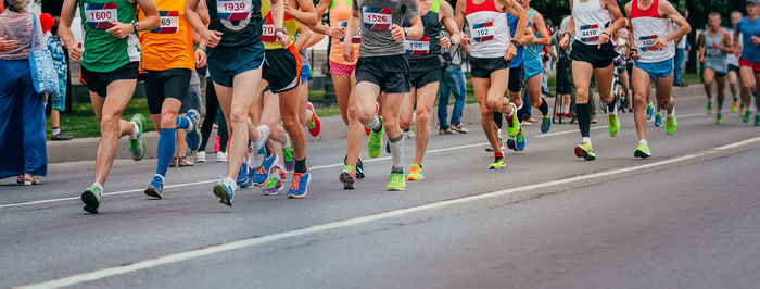 Low section of people walking on road