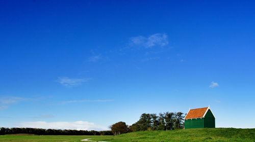 Scenic view of grassy field against cloudy sky