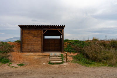 Built structure on field against sky