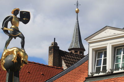 Low angle view of statue against building