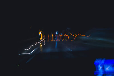 Close-up of light painting against black background