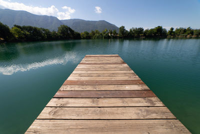 Pier over lake against sky