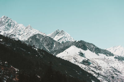 Scenic view of snowcapped mountains against clear sky