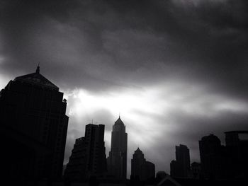Low angle view of modern building against cloudy sky