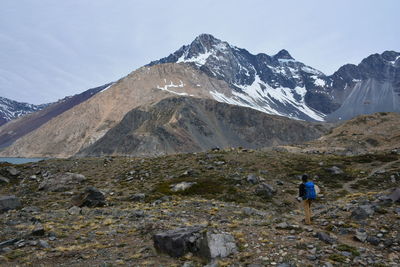 Man standing against snowcapped mountains