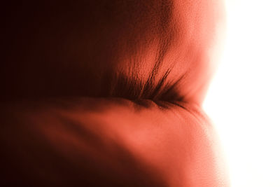 Close-up of woman with red hair over white background