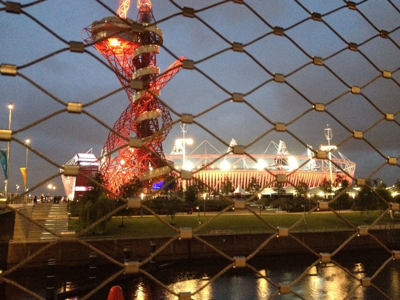 illuminated, architecture, built structure, decoration, lighting equipment, building exterior, pattern, indoors, hanging, metal, night, design, city, no people, chainlink fence, ceiling, sky, fence, protection