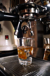 Fresh espresso shot pouring out of machine.