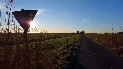 View of field against sky during sunset