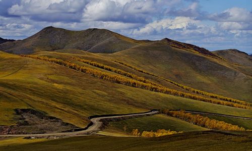 Scenic view of mountains against cloudy sky