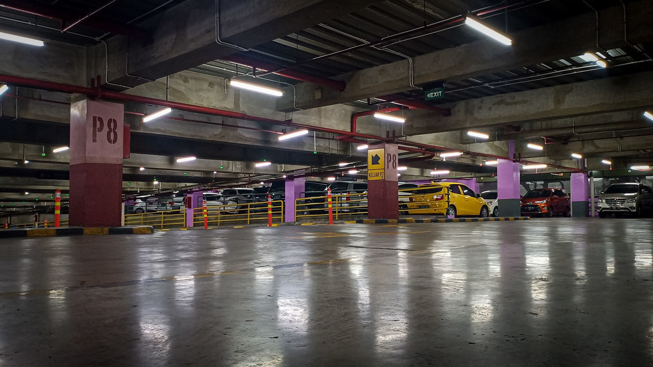 architecture, indoors, transportation, parking lot, built structure, parking, illuminated, transport, public transport, mode of transportation, sport venue, warehouse, domestic room, architectural column, building, no people, parking garage, industry, lighting equipment