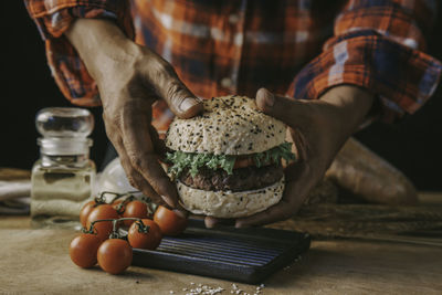 Midsection of man preparing food on table