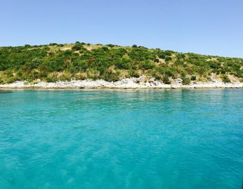 Scenic view of sea against clear blue sky