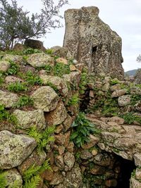 Low angle view of old stone wall against sky