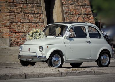 Vintage car on street against wall