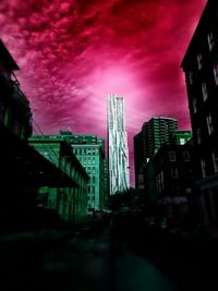 View of buildings against cloudy sky at sunset