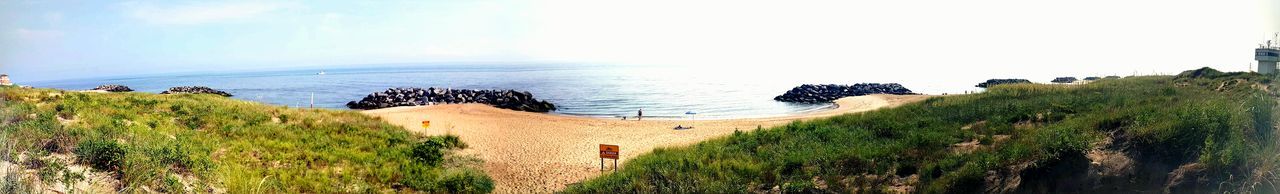 Panoramic view of beach against clear sky