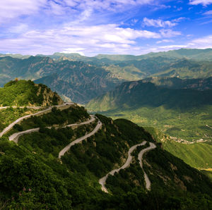 Scenic view of mountains against cloudy sky