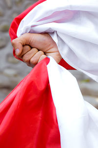 Low section of woman holding flag