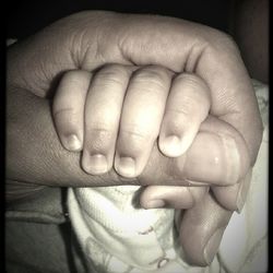 Close-up of hand holding baby